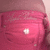 A static image of a pink and red gradient background with a small white circular highlight in the center.