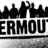 Black and white pixelated image showing a city skyline above the partial text 'ERMOUT' with a horizontal line below.