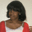 Pixelated static image of a person with short dark hair wearing red and white clothing against a light background.