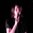 Pixelated image of a person with light skin and dark hair holding a camera, next to white pixelated text on a black background.
