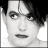 Four black-and-white show a person with dark tousled hair and heavy eye makeup in different poses against white backgrounds