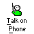 Pixelated green figure holding a phone to its ear with white face and black eyes, under text reading 'Talk on Phone' on gray background.