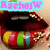 A close-up of lips with colorful candy-like patterns and a blue text overlay reading "RachejW" in pink letters.