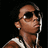Pixelated image of a person wearing sunglasses, white earbuds, and a sleeveless shirt with white stripes, set against a black background.