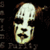 Pixelated static icon of a stylized human skull with brown hair, white face, and black eye sockets against a dark background.