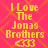 Yellow pixelated text on pink background reads "I Love The Jonas Brothers" with heart symbols, repeated in a pattern