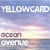 Pixelated static image of a sunset sky with text overlays reading "YELLOWCARD" at top, "00:01" in middle-left, and "SUNSET" at bottom over water reflection.
