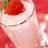 Pixelated image of a pink drink with whipped cream and strawberry on top, set against a light pink background with green text.