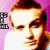 Pixelated static image of a person's face with brown hair and white shirt against pink background, featuring partial text on left side.