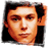Static 48x48 pixel icon showing a close-up of a person's face with orange-brown skin tones and dark hair against a black background, rendered in low-resolution pixel art style.