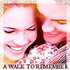 Two people in close proximity with closed eyes and smiles, wearing patterned clothing, with text at the bottom reading "A WALK TO REMEMBER".
