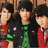 Three individuals in red and green clothing stand against a blue background with pink text reading 'Jonas Brothers' and 'ROCK!!!'