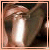 Pixelated image with peach border showing a blurred background of hands and text blocks in white pixel font on black rectangles.