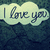 A cloud-shaped text bubble with "I love you" in cursive script on a dark blue patterned background, displayed