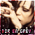 Pixelated image of two people kissing, with text "DIR EN GREY" in pink and white block letters at the bottom.