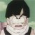 Static pixelated image of a character with black bowl-cut hair, light skin, and a black sleeveless top against a greenish background.