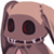 Pixelated cartoon character with brown skin, large black eyes with red highlights, and a wide toothy grin on a white background.