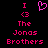 Pixelated pink text and symbols on black background, showing 'I <3 The Jonas Brothers' with a heart symbol in two states.