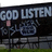 Static pixel art icon with dark background, light blue text reading "GOD LISTEN" at top and stylized Japanese characters below, a small pink square on left side.