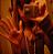 A static pixelated image with warm orange and brown tones, featuring indistinct shapes that suggest a figure in motion against a blurred background.