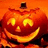 A pixelated orange pumpkin with glowing eyes and mouth on a solid orange background, next to 'HAPPY HALLOWEEN' text.
