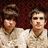 Two distinct images displayed in a with text labels: a photo of two people in light shirts against a red background and a group photo of three people on a grassy field