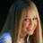 A pixelated image of a person with long light brown hair against a dark background, next to a pink with red pixelated text reading 'hannah montana rox!' in three lines