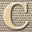 Static 48x48 pixel icon featuring a stylized letter C with a beige fill and dark outline against a checkered background, rendered in low-resolution pixel art style.
