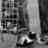 A split-screen image with a grayscale photo of legs in jeans and shoes on the left, red background sections containing pixelated white text reading "LOVE IS LIKE WIND" at top right, "U CNT SEE IT BUT" at bottom left, and "yu can feel it!" at bottom right.