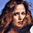 A 2x2 contact sheet of four pixelated frames showing a woman with long curly brown hair in different expressions, with "Coolbuddy.com" text on the bottom-right frame against a black background.