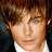 Pixelated image of a person with brown hair and blue eyes on a pink background with white text.