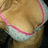 A pixelated close-up of a light brown curved surface with pink and white accents along the lower edge.