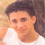 A pixelated image of a person in a white shirt with text overlays reading "i Love" and "THIS boy..." in red and blue pixelated fonts.