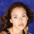 Static pixelated image of a person with dark brown hair against blue background, wearing light-colored top.