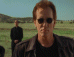 A sequence of five horizontal showing a man in sunglasses and dark jacket against grassy field background, with progressive zoom from full-body to close-up face