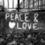 Black-and-white pixelated image showing 'PEACE R' above a heart symbol and 'LOVE', with vertical bars in the background.