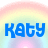 Pixelated blue text 'KATY' on a pastel rainbow gradient background with soft pink and yellow hues.