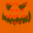 A pixelated orange pumpkin face with dark green eyes and mouth, displaying red text reading 'trick or treat smell my feet' across its features.