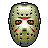 Pixelated mask with greenish-brown tones, black eye holes, red accents on forehead and cheeks, white nose area, and dark gray side attachments.