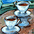 Two white ceramic cups filled with brown liquid on a wooden surface, set against a blurred blue-green background.
