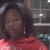 A static pixelated image shows a person with dark hair wearing a red top, positioned against an indistinct background.