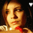 A pixelated image of a person with light brown hair wearing a red bow tie and white collar, featuring two distinct visual states: one with a heart symbol above the head and another with a musical note.