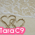 Beach scene with two heart shapes drawn in sand, wave in background, and text "TaraC9" in colored boxes.