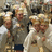 Pixelated image of four people in light-colored clothing with one person in dark blue shorts, alongside text about hats from Santa.