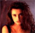 Pixelated image of a person with long dark hair wearing a sleeveless top against a dark background.