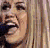 Pixelated image of a person with long blonde hair singing into a microphone on the left, next to pink background with bold black text reading HANNAH MONTANA! and a stylized Q symbol.