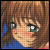 Pixelated close-up of a character with brown hair, green eyes, and a blue garment against a brown background.