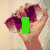 A pixelated image of a person holding sunglasses with a green rectangle over the face, and purple text reading "VESOM" at the bottom.