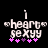 Pixelated text 'i heart sexy' with pink and purple plus signs below, two versions showing color variation in the plus signs.
