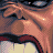 Pixelated close-up of a face with brown skin tone, dark eyes, and red lips against warm-toned background.